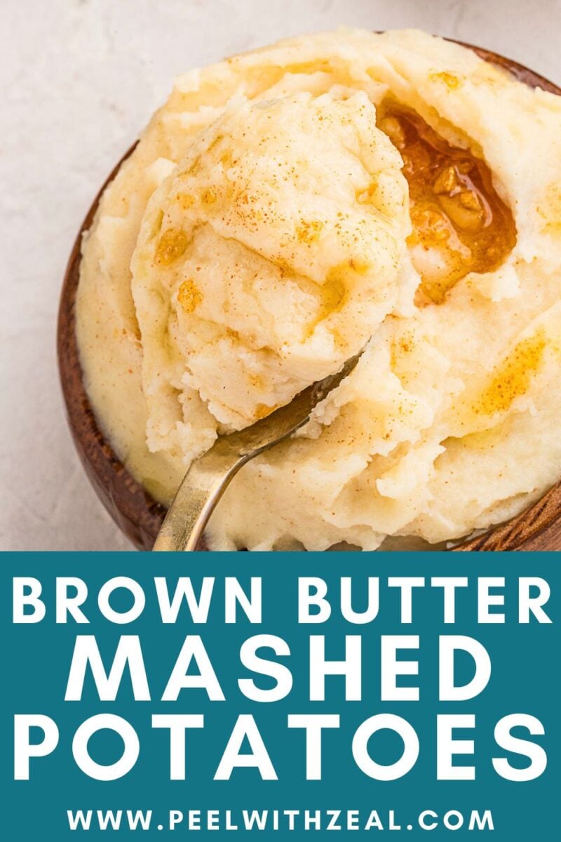 A bowl of creamy mashed potatoes topped with rich brown butter sits invitingly, a spoon ready to dive in. Viewed from above, the text at the bottom reads “Brown Butter Mashed Potatoes www.peelwithzeal.com”.