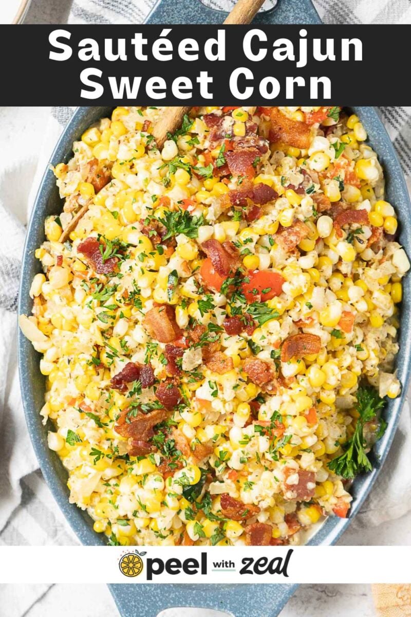 Oval dish filled with sautéed sweet corn, bacon pieces, and chopped herbs, shown from above. Inspired by classic Maque Choux, this dish brings Cajun flavors to your table. Text overlay reads “Sautéed Cajun Sweet Corn.”.