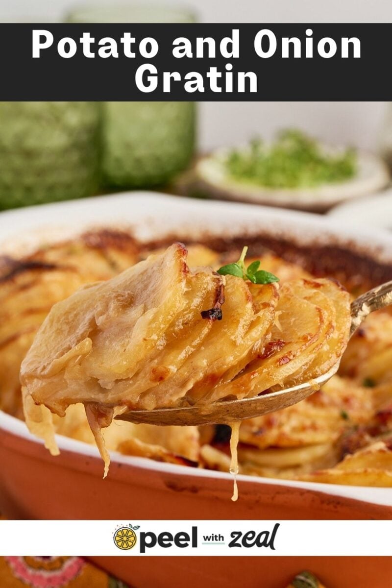 A spoonful of French onion potatoes gratin being lifted from a baking dish.